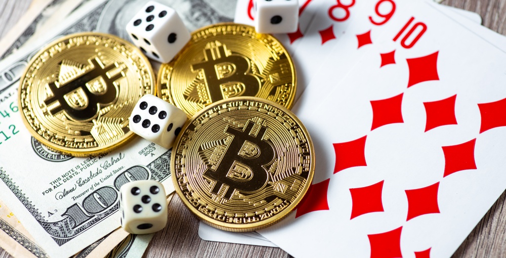 Bitcoins, cards, dices on wooden background. Cryptocurrencies gambling concept