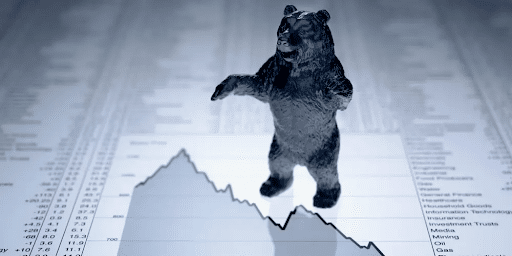Bear market: a bear standing on a declining price chart.