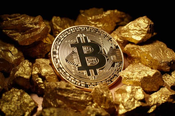 Bitcoin on a pile of gold, symbolizing a store of value purpose of BTC